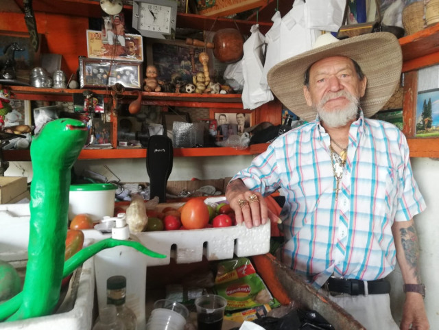 El fruver de Juver Antonio Melchor Díaz tiene clientes fieles por dos motivos: sus productos y su conversación. Ocasionalmente saca su guitarra y ambienta la Plaza de Mercado de Riosucio.