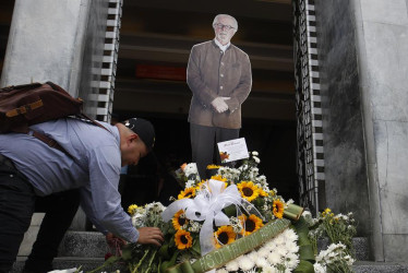  Personas colocan ofrendas florales en una imagen del maestro Fernando Botero durante un homenaje tras su fallecimiento, hoy, en la entrada del Museo de Antioquia en la Plaza Botero, en Medellín 