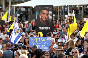 La gente se reúne para ver una transmisión en vivo en una pantalla gigante que informa sobre la liberación del rehén soldado israelí-estadounidense Edan Alexander