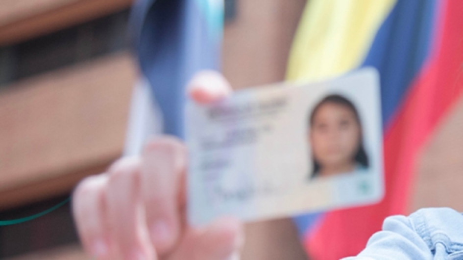 Manos sosteniendo una tarjeda de identidad colombiana