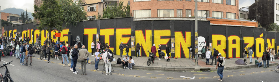 Fotografía panorámica de integrantes de colectivos artísticos pintando un grafiti este viernes, en Bogotá. 