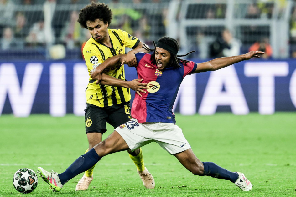 Jules Kounde (R) del Barcelona en acción contra Karim Adeyemi del Dortmund.