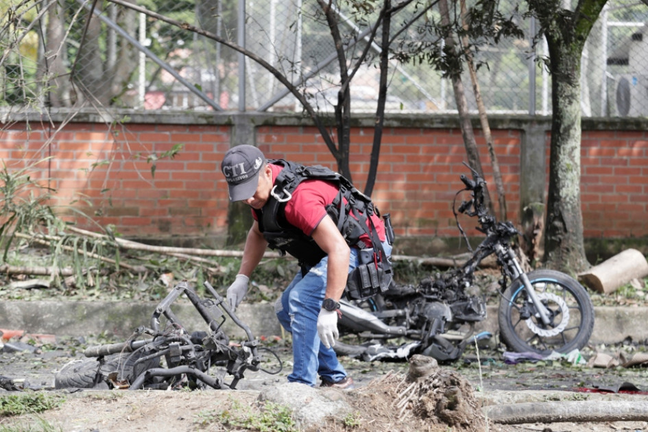 Un perito forense trabaja en los alrededores de la estación de policía del barrio Meléndez donde ocurrió un atentado este martes, al sur de Cali (Colombia).